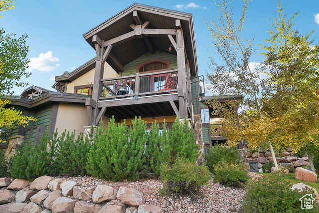 Back of property featuring a balcony