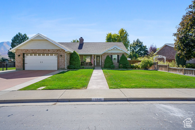 View of front of house featuring a front yard and a garage