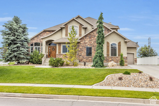 Craftsman inspired home with a front yard and a garage