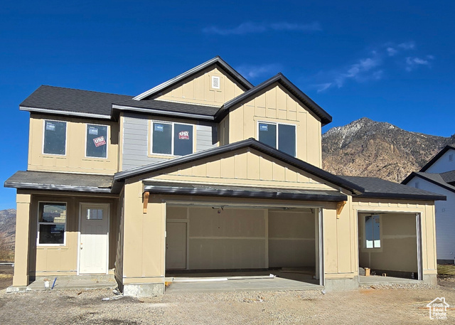 View of front facade featuring a mountain view and a garage