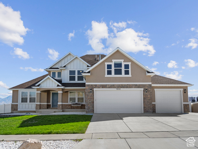 Craftsman-style home featuring a 3 car garage