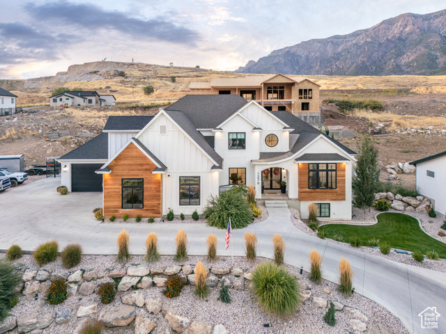 View of front of house featuring a mountain view and a garage