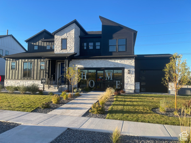 View of front of property featuring a front lawn and a porch