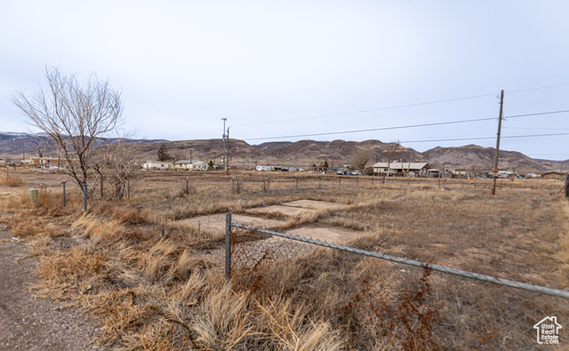 View of yard with a rural view and a mountain view