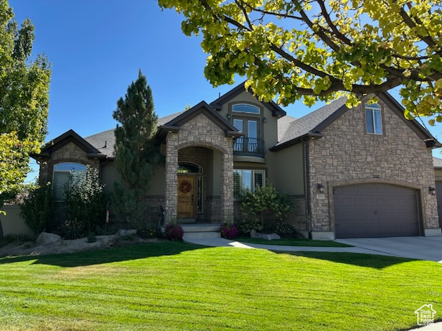 French provincial home featuring a front yard