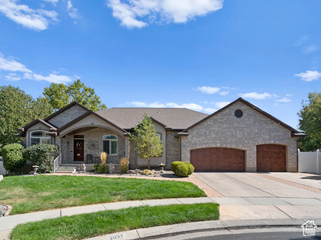 View of front of house featuring a front yard and a garage