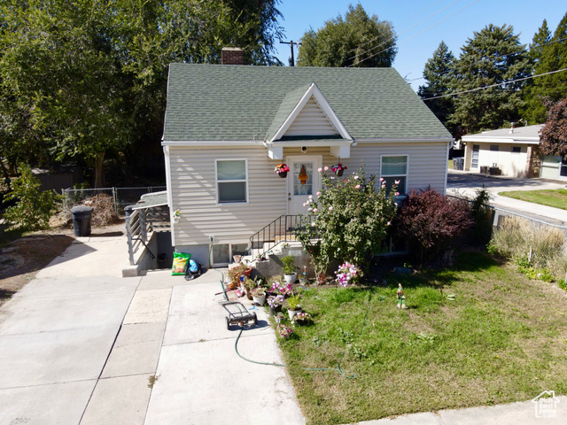 Bungalow-style house with a front lawn