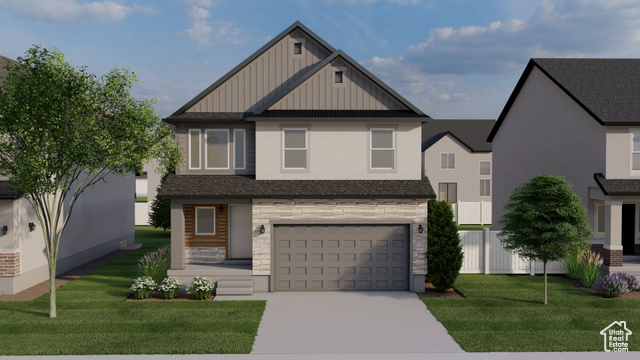 View of front of house featuring a garage and a front lawn