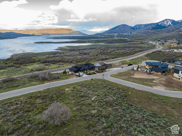 Drone / aerial view featuring a water and mountain view