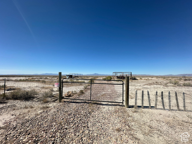 View of yard with some structures started. Well inside this fenced area