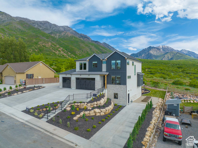 View of front facade featuring a mountain view and a garage