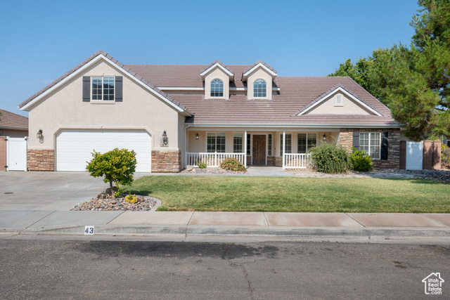 View of front facade featuring a front lawn and a porch