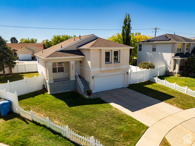 View of front of home featuring a garage and a front yard