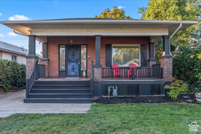 Exterior space with a front yard and a porch