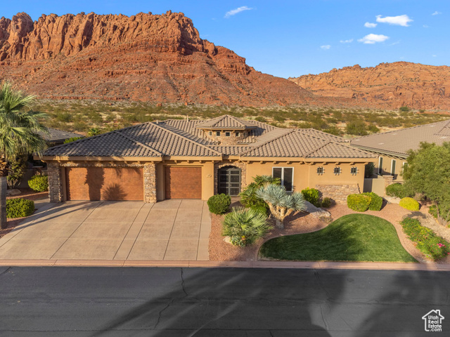 View of front of house with a garage and a mountain view