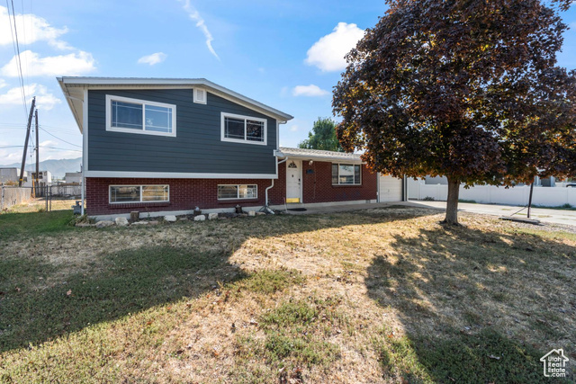 Split level home featuring a front lawn