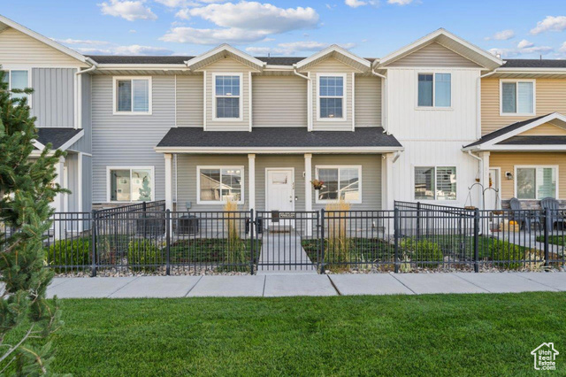 View of property with a front lawn.