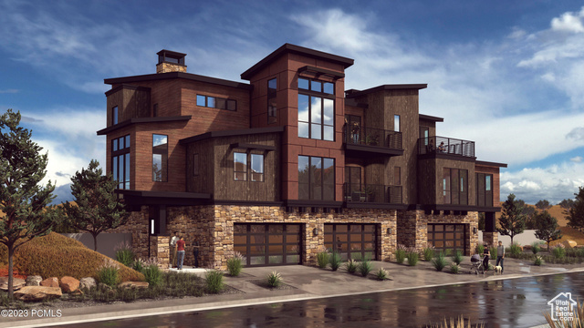 View of front of property with a balcony and a garage