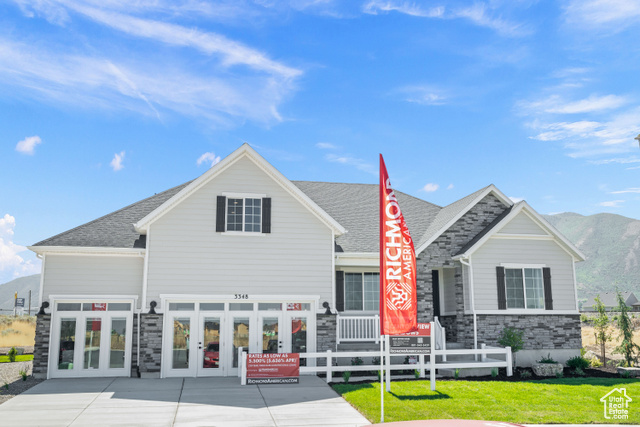 Rear view of property featuring french doors, a mountain view, and a yard