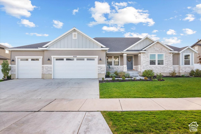 Craftsman-style home with a front lawn and a garage