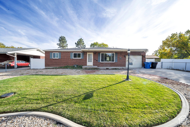 Ranch-style. Brick house with a front yard and a 1-car garage