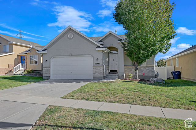 View of front of home featuring a garage and a front lawn