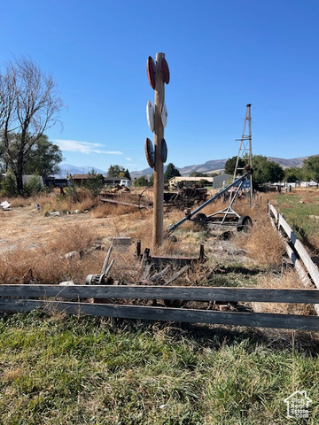 View of yard with a rural view and a mountain view