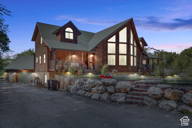 View of front of home featuring a garage and covered porch