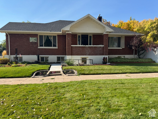 View of front of property with a front lawn and central air condition unit