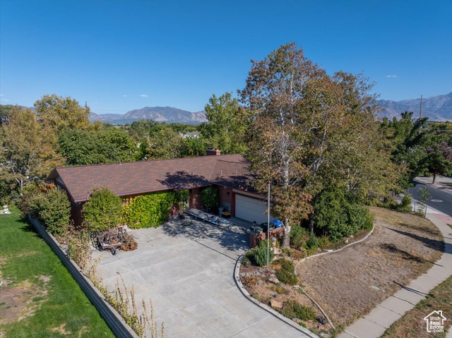 Ranch-style home featuring a garage and a mountain view