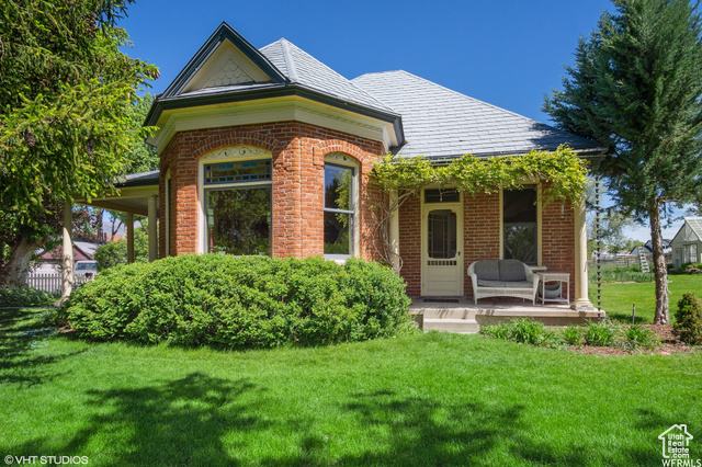 Exterior space featuring a front yard and a porch