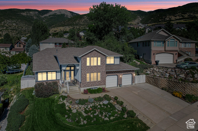 View of front of house with a mountain view and a garage