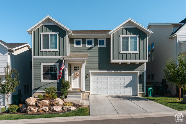 View of front facade featuring a garage