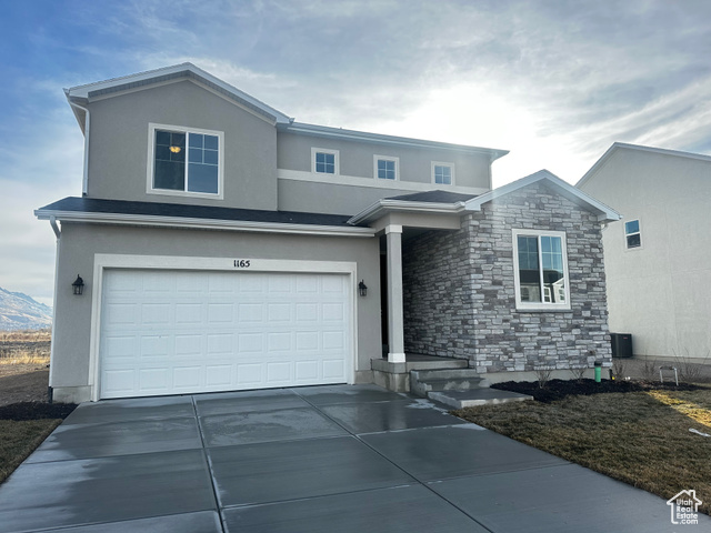 View of front facade featuring a garage