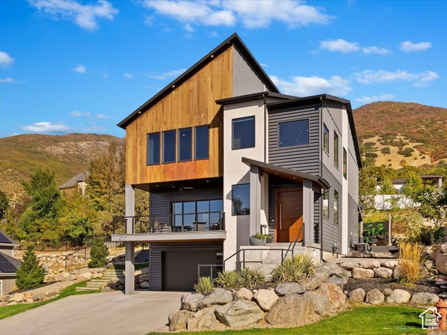 View of front of home featuring a garage and a mountain view