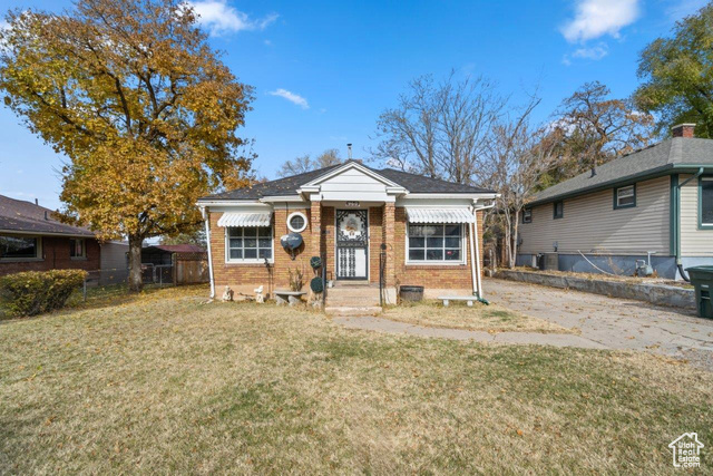 Bungalow-style house featuring a front yard