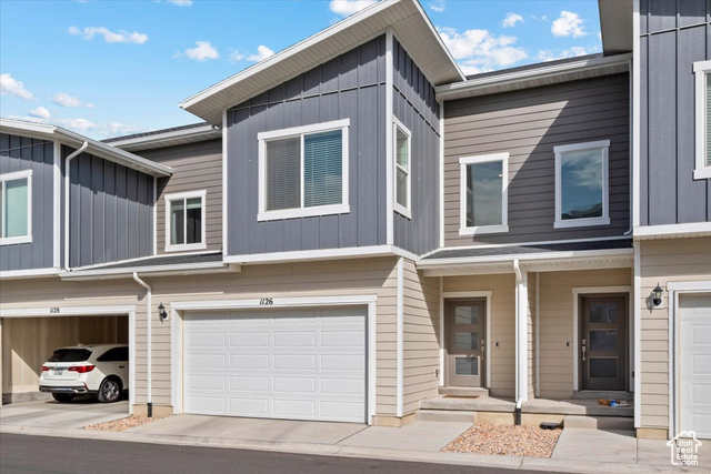 Townhome / multi-family property featuring a garage