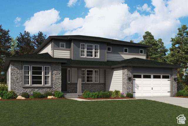 View of front facade with a front lawn and a garage