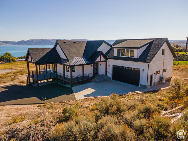 View of front facade with a mountain view, a porch, and a garage