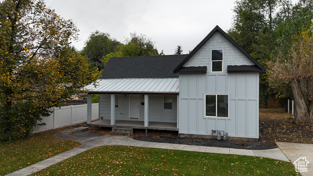 View of front of house with a front yard and a porch