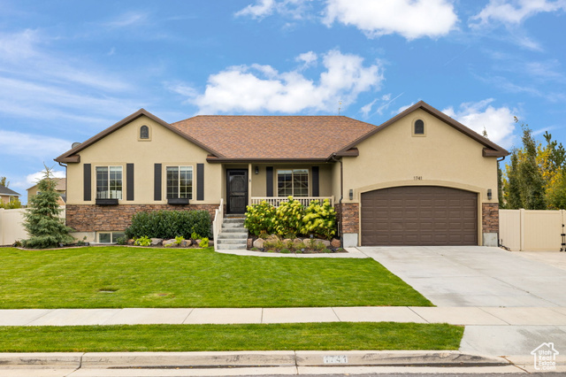 View of front facade with a front yard and a garage