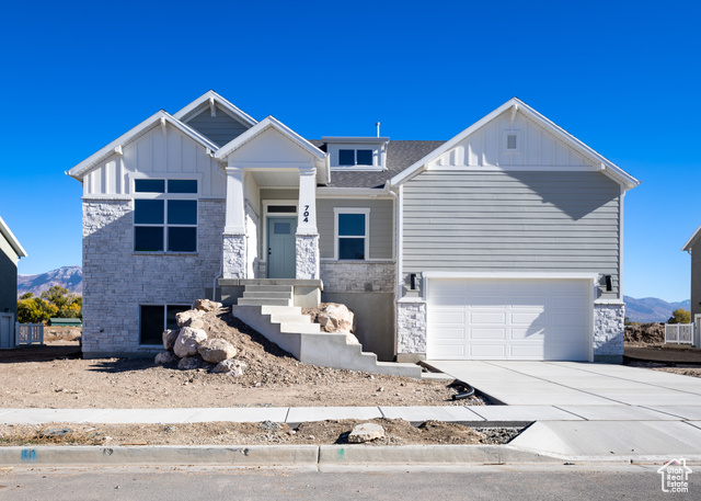 View of front facade with a garage and a mountain view