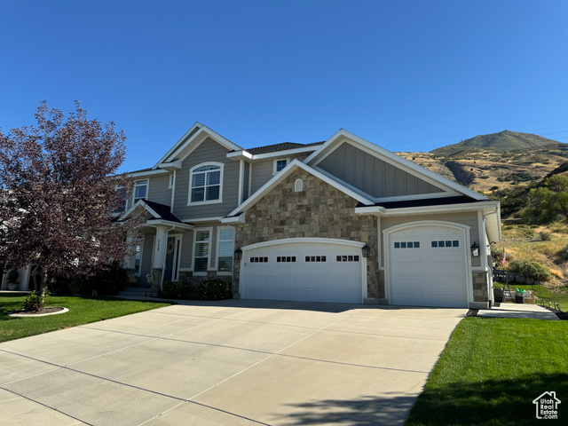 Craftsman-style home with a mountain view and a front lawn