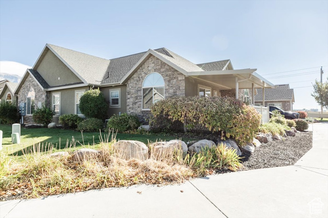 View of side of home featuring a lawn