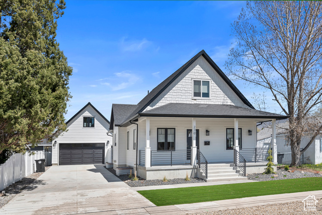 View of front of home with covered porch and a garage