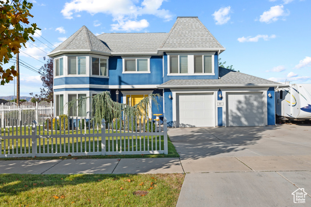 View of front facade with a front yard and a garage