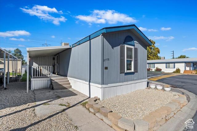 View of side of home with a carport