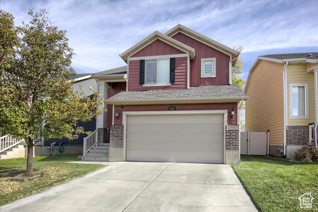 View of front of home featuring a garage and a front lawn