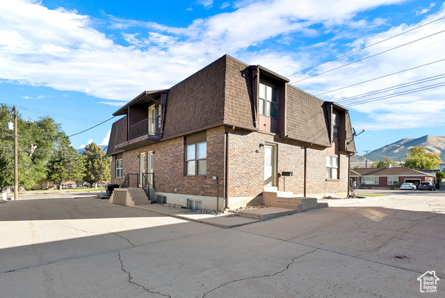 View of home's exterior with a balcony and a mountain view