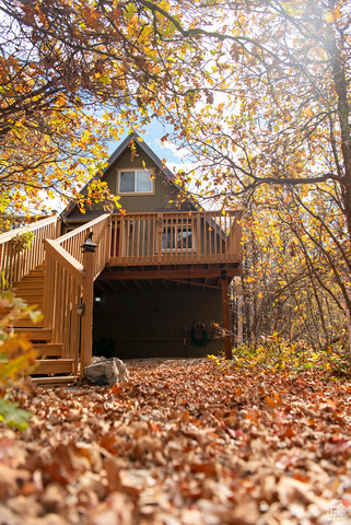 Front view of property featuring a wooden deck